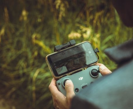 person holding black and gray digital camera