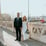 man in black suit standing beside woman in white wedding dress