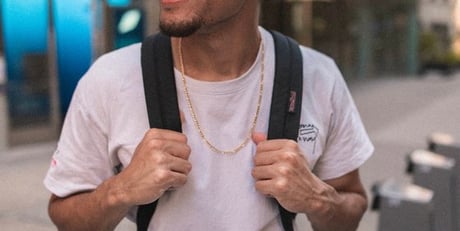 man in white crew neck t-shirt wearing blue cap and black sunglasses