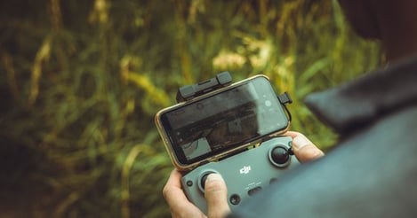 person holding black and gray digital camera