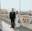 man in black suit standing beside woman in white wedding dress
