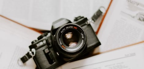 black nikon dslr camera on white printer paper