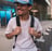 man in white crew neck t-shirt wearing blue cap and black sunglasses