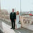 man in black suit standing beside woman in white wedding dress