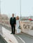 man in black suit standing beside woman in white wedding dress