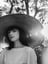 woman in white crew neck shirt wearing brown sun hat