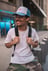man in white crew neck t-shirt wearing blue cap and black sunglasses