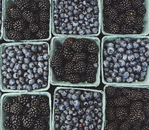 black berries on black surface
