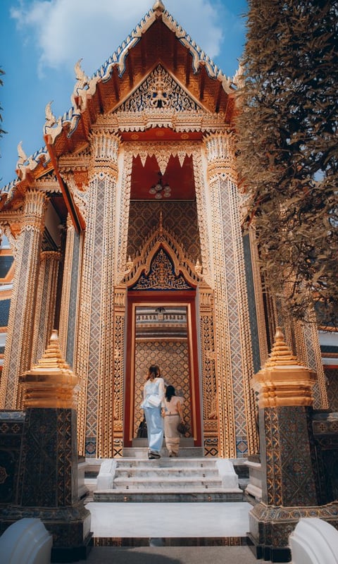 man and woman standing in front of brown concrete building during daytime