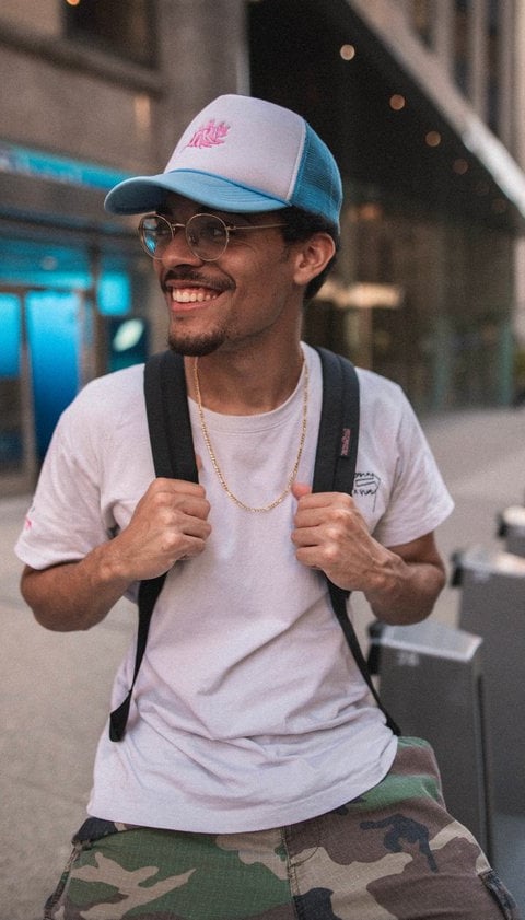 man in white crew neck t-shirt wearing blue cap and black sunglasses