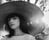 woman in white crew neck shirt wearing brown sun hat