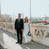 man in black suit standing beside woman in white wedding dress
