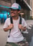 man in white crew neck t-shirt wearing blue cap and black sunglasses