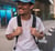 man in white crew neck t-shirt wearing blue cap and black sunglasses
