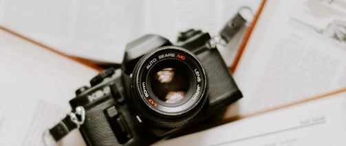 black nikon dslr camera on white printer paper
