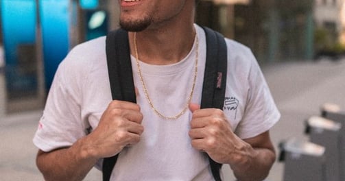 man in white crew neck t-shirt wearing blue cap and black sunglasses