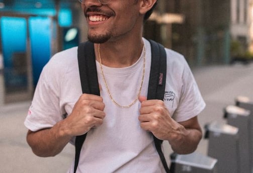 man in white crew neck t-shirt wearing blue cap and black sunglasses