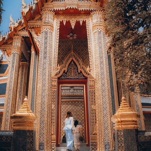 man and woman standing in front of brown concrete building during daytime