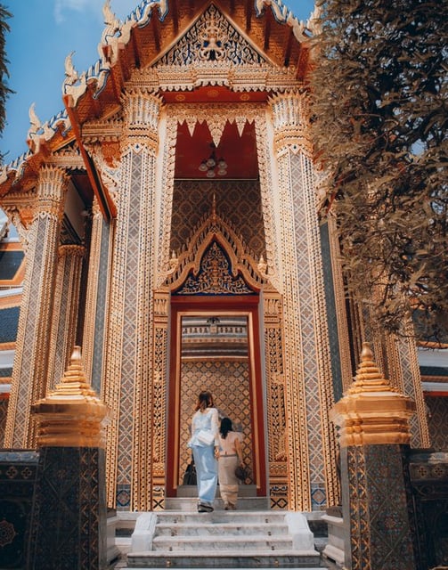 man and woman standing in front of brown concrete building during daytime