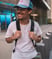 man in white crew neck t-shirt wearing blue cap and black sunglasses