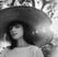 woman in white crew neck shirt wearing brown sun hat