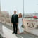 man in black suit standing beside woman in white wedding dress