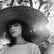 woman in white crew neck shirt wearing brown sun hat