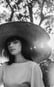 woman in white crew neck shirt wearing brown sun hat