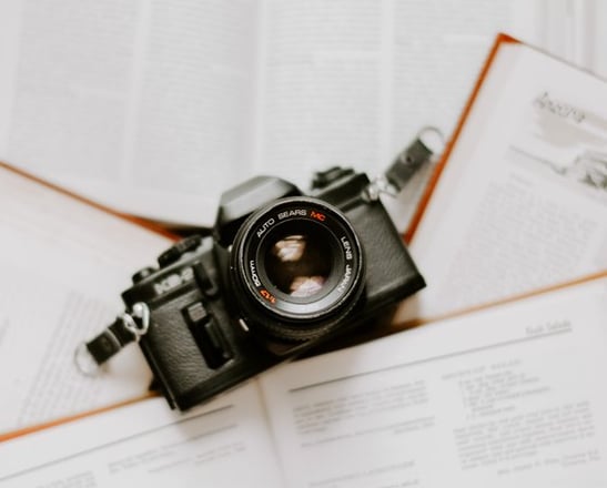 black nikon dslr camera on white printer paper