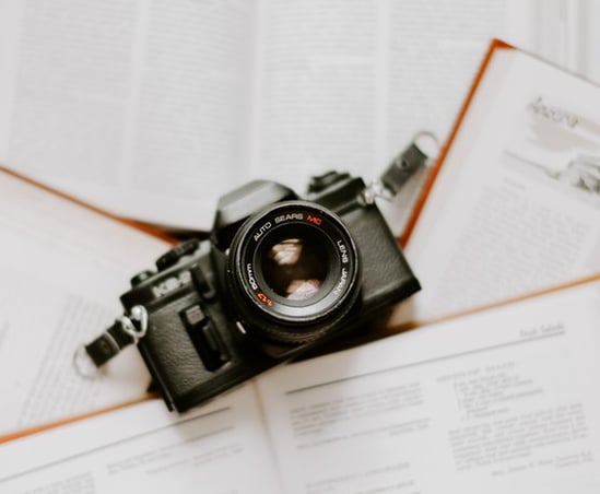 black nikon dslr camera on white printer paper
