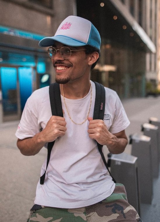man in white crew neck t-shirt wearing blue cap and black sunglasses