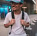 man in white crew neck t-shirt wearing blue cap and black sunglasses