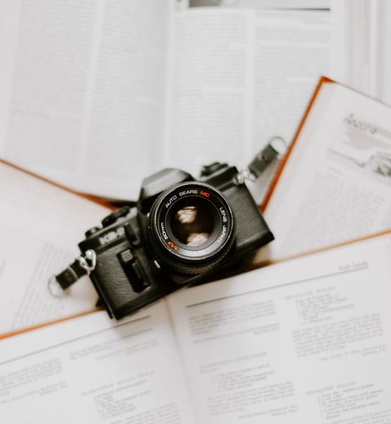 black nikon dslr camera on white printer paper