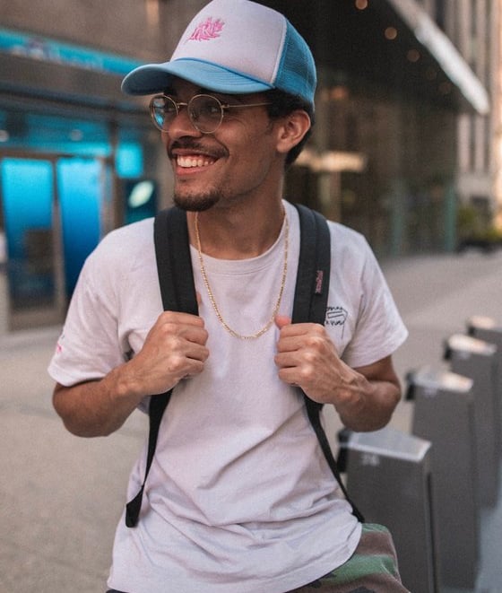 man in white crew neck t-shirt wearing blue cap and black sunglasses