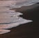 ocean waves crashing on shore during daytime