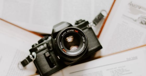 black nikon dslr camera on white printer paper