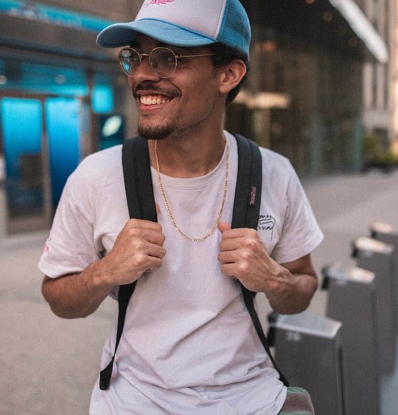man in white crew neck t-shirt wearing blue cap and black sunglasses