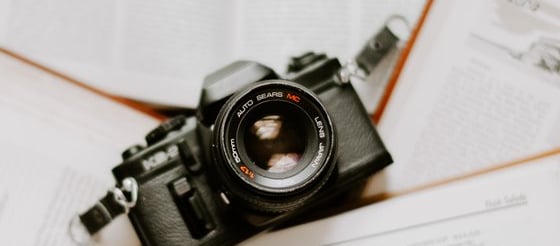 black nikon dslr camera on white printer paper