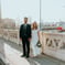 man in black suit standing beside woman in white wedding dress