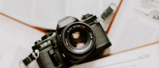 black nikon dslr camera on white printer paper