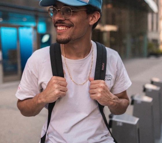 man in white crew neck t-shirt wearing blue cap and black sunglasses