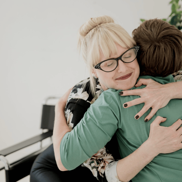 Ester hugging a client after a therapy session