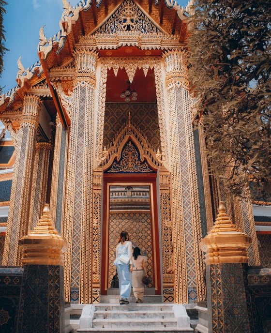 man and woman standing in front of brown concrete building during daytime