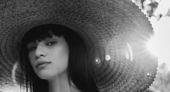 woman in white crew neck shirt wearing brown sun hat