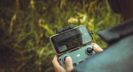 person holding black and gray digital camera