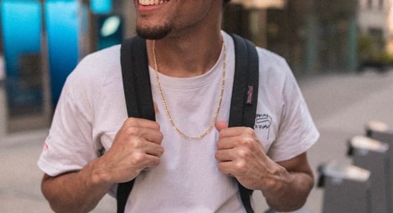 man in white crew neck t-shirt wearing blue cap and black sunglasses