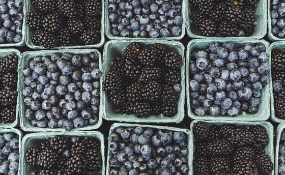 black berries on black surface