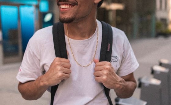 man in white crew neck t-shirt wearing blue cap and black sunglasses