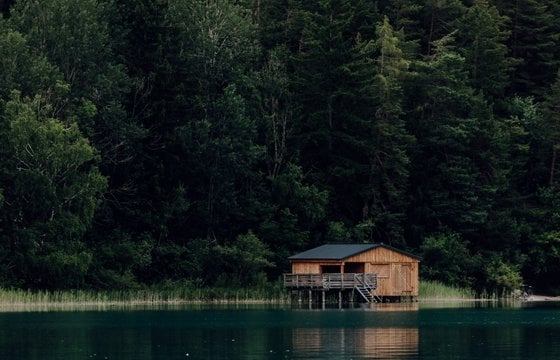 brown wooden house on lake