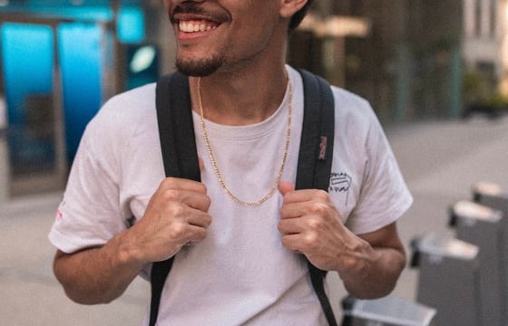 man in white crew neck t-shirt wearing blue cap and black sunglasses